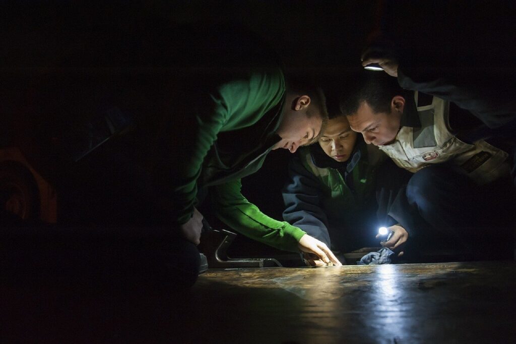 maintenance workers inspecting floor flashlights